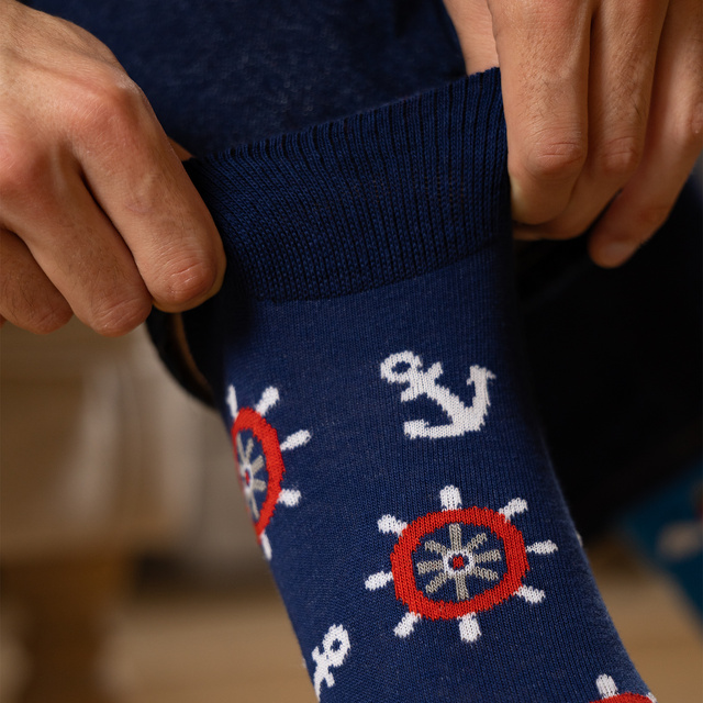 Colorful mismatched SOXO GOOD STUFF socks lighthouse